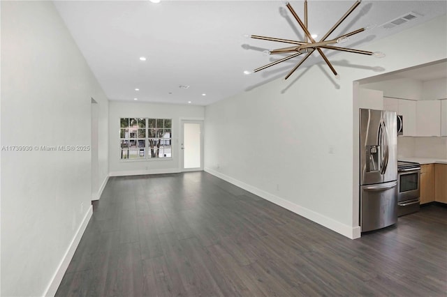 unfurnished living room featuring dark wood-style flooring, visible vents, and baseboards