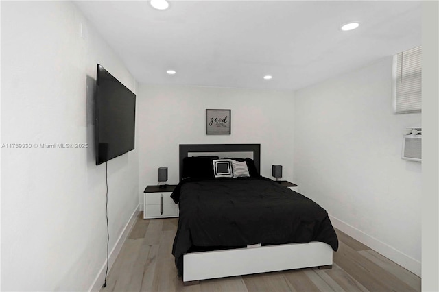 bedroom with light wood-type flooring, baseboards, and recessed lighting