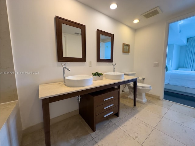 bathroom with toilet and vanity