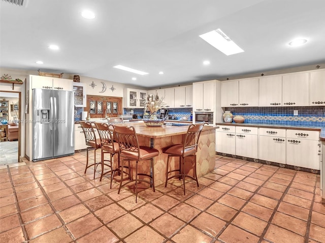 6200 SW 112th St, Pinecrest, FL 33156 - kitchen with stainless steel appliances, tasteful backsplash, glass insert cabinets, a kitchen island, and recessed lighting
