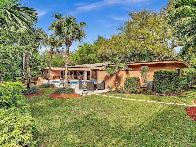6200 SW 112th St, Pinecrest, FL 33156 - back of property with stucco siding, an outdoor pool, a patio, and a yard