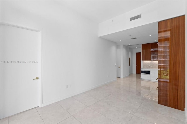 unfurnished living room featuring light tile patterned floors