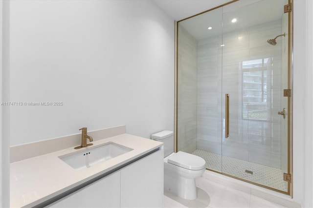 bathroom with vanity, a shower with door, toilet, and tile patterned floors