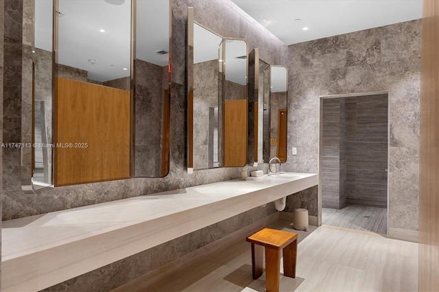 bathroom featuring a shower and tile walls