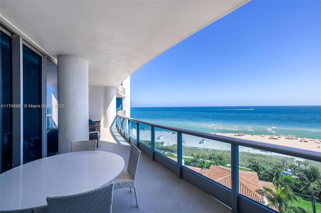 balcony featuring a water view and a view of the beach