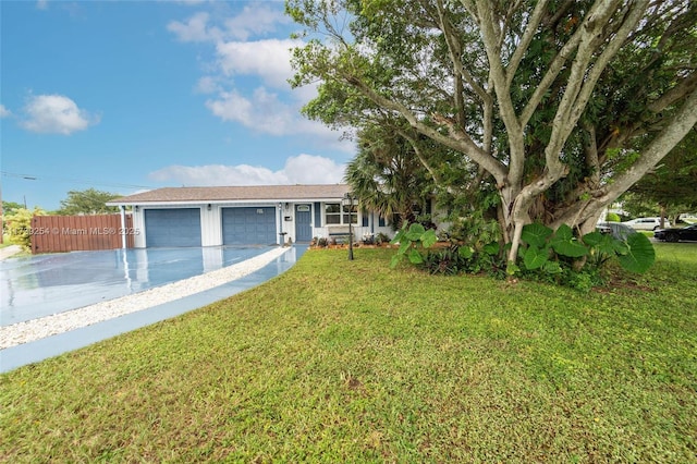 view of front of property featuring a front lawn and a garage