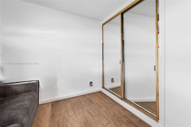 interior space featuring baseboards and wood finished floors