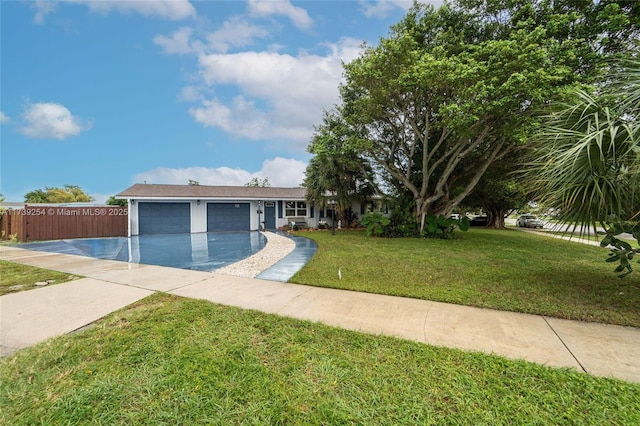 single story home with driveway, a garage, a front lawn, and fence