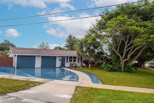 single story home with driveway, a garage, and a front yard