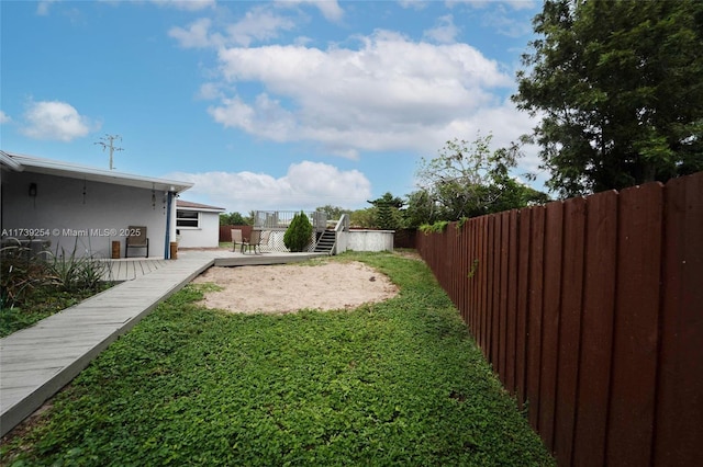 view of yard featuring a fenced backyard and a deck