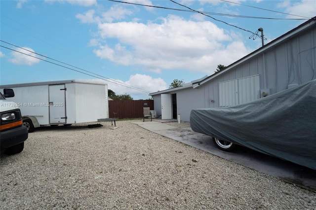 view of side of property featuring fence and a patio