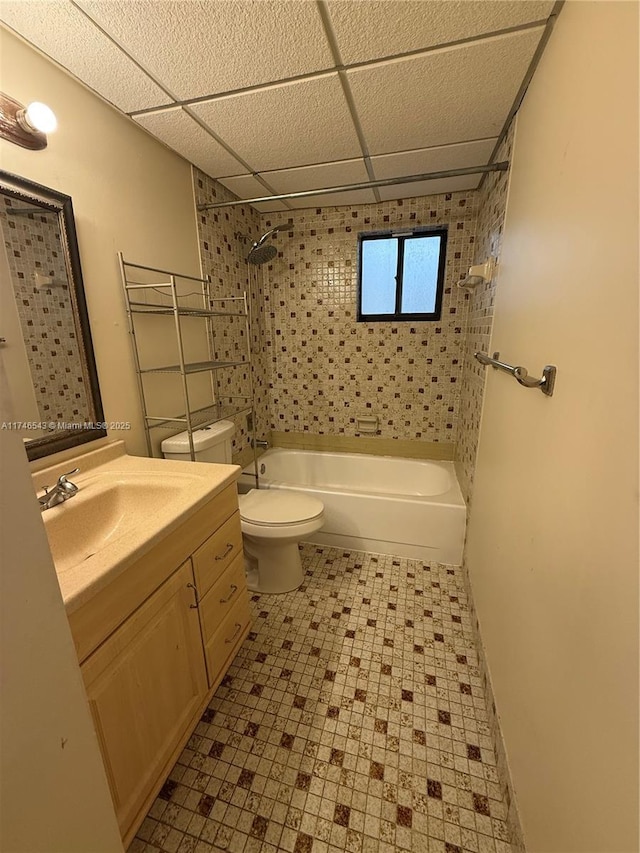 bathroom featuring shower / bath combination, vanity, toilet, and a drop ceiling