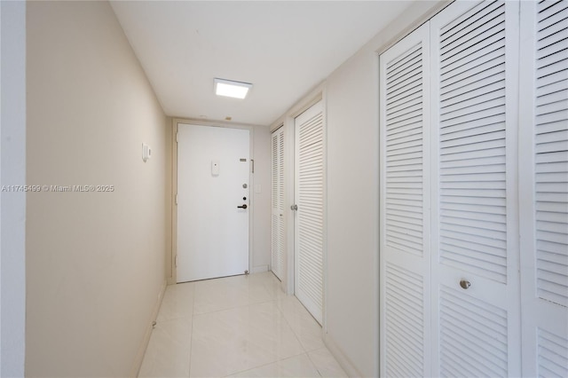 corridor featuring light tile patterned flooring