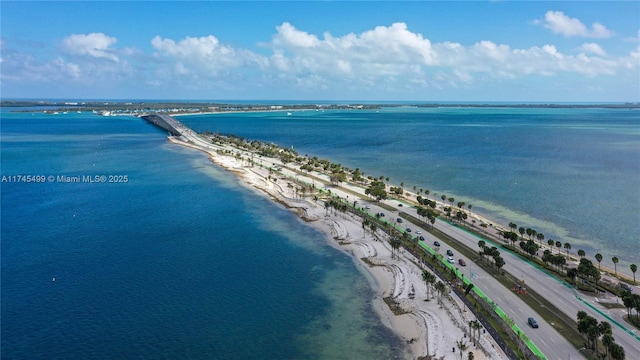 birds eye view of property featuring a water view and a view of the beach