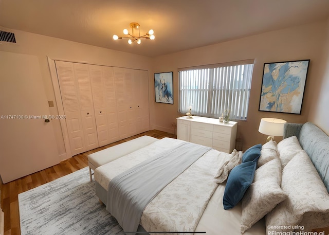 bedroom featuring a closet, hardwood / wood-style flooring, and an inviting chandelier