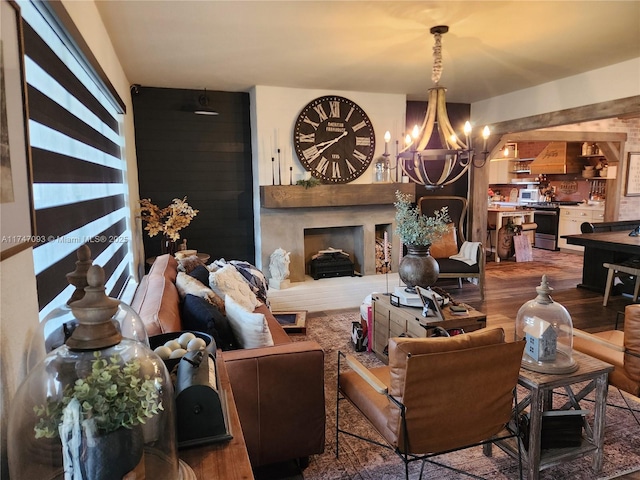 living room with hardwood / wood-style flooring and a notable chandelier