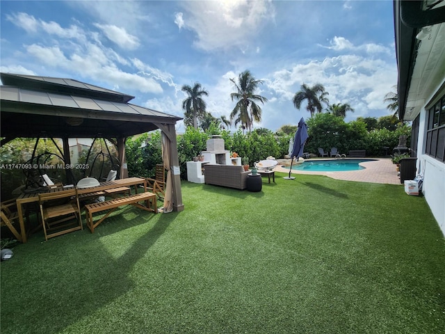 view of yard featuring a fireplace, a patio, and a gazebo