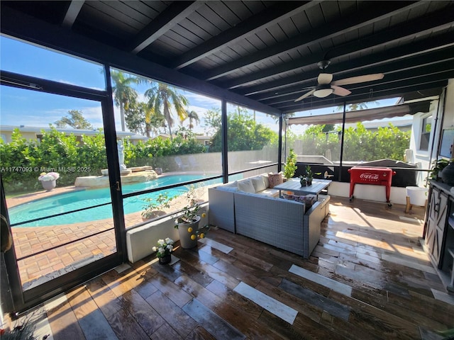 sunroom / solarium featuring beam ceiling, ceiling fan, and wooden ceiling