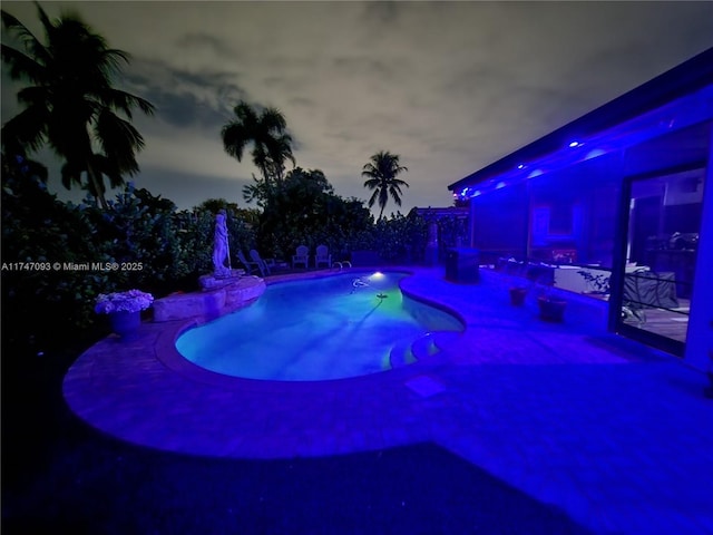 view of pool at dusk