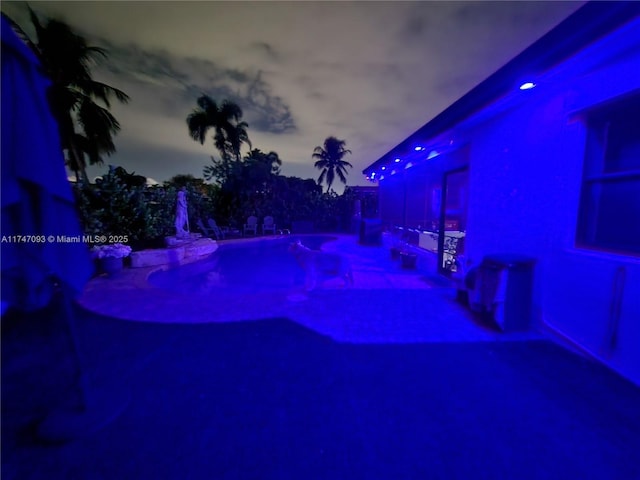 view of pool at dusk