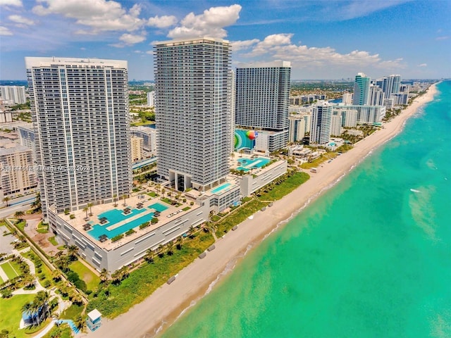 drone / aerial view featuring a water view and a view of the beach