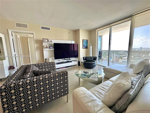 tiled living room with floor to ceiling windows