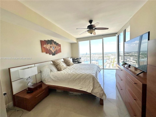 bedroom with a wall of windows, access to outside, light tile patterned flooring, and ceiling fan