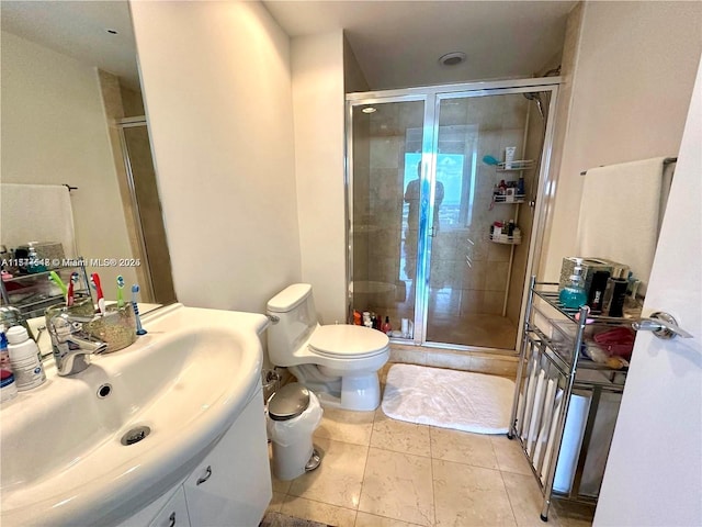 bathroom with toilet, an enclosed shower, and vanity