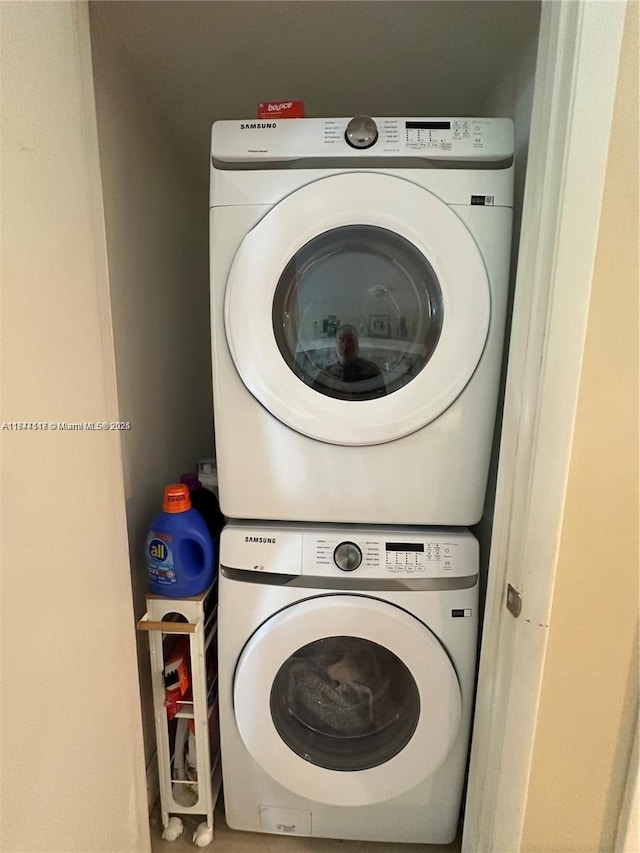 laundry area with stacked washing maching and dryer