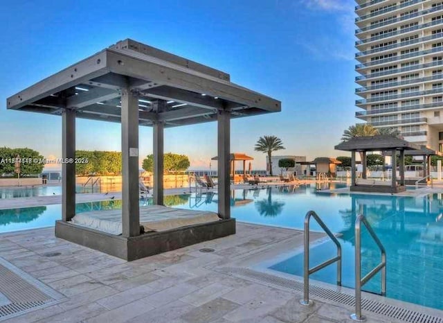 view of swimming pool with a patio and a gazebo