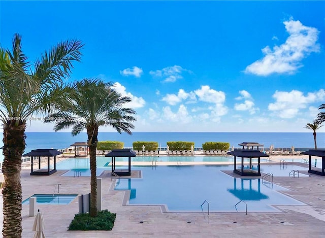 view of swimming pool featuring a water view and a gazebo