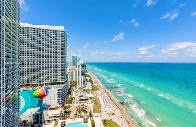 aerial view with a water view and a view of the beach