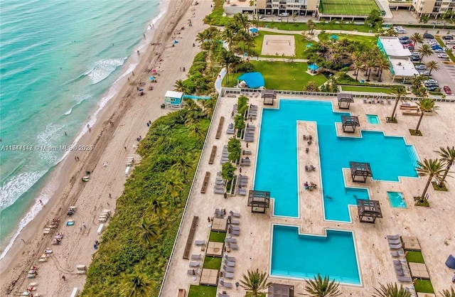 drone / aerial view featuring a water view and a view of the beach