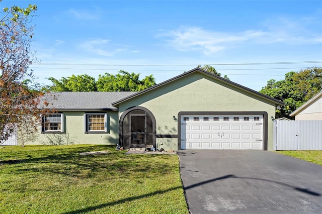 ranch-style house featuring a front lawn and a garage