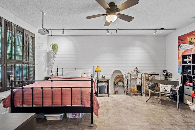 bedroom featuring a textured ceiling and light parquet floors