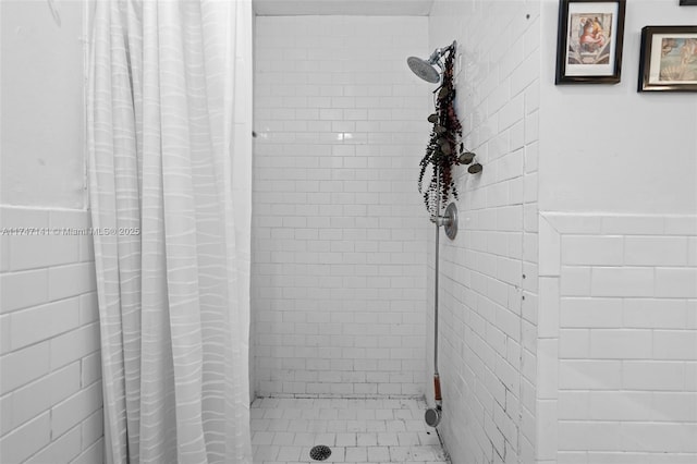 bathroom with tile walls and walk in shower