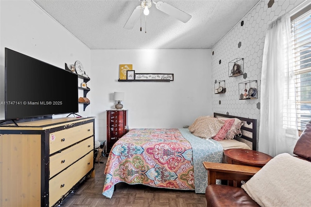 bedroom featuring a textured ceiling and dark parquet floors