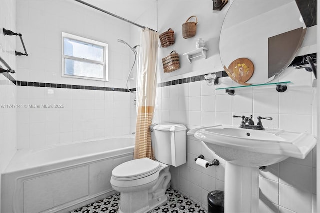 bathroom featuring shower / bath combo with shower curtain, tile walls, and toilet