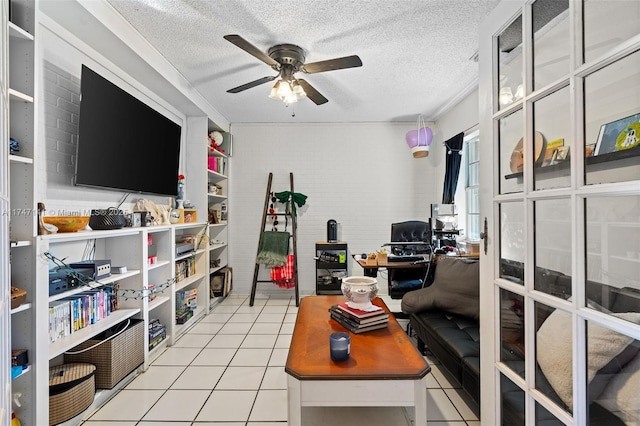 tiled office featuring ceiling fan and a textured ceiling