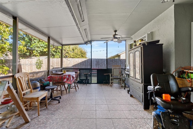 sunroom featuring ceiling fan