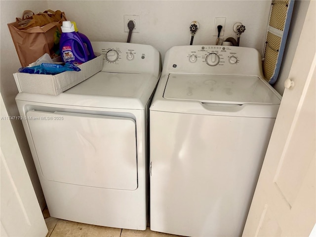 laundry area with light tile patterned flooring and independent washer and dryer