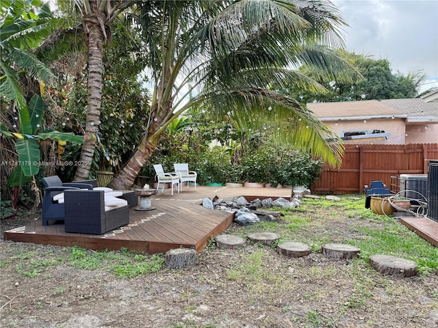 view of yard with a deck and central air condition unit