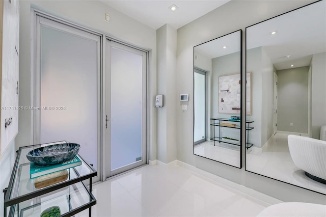 bathroom with recessed lighting and baseboards