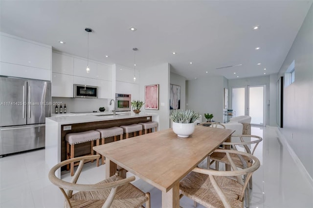 dining room with light tile patterned flooring and recessed lighting