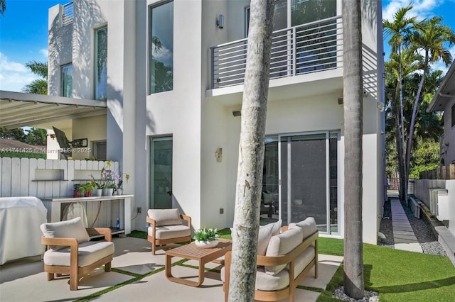 view of patio / terrace featuring an outdoor hangout area, area for grilling, and a balcony