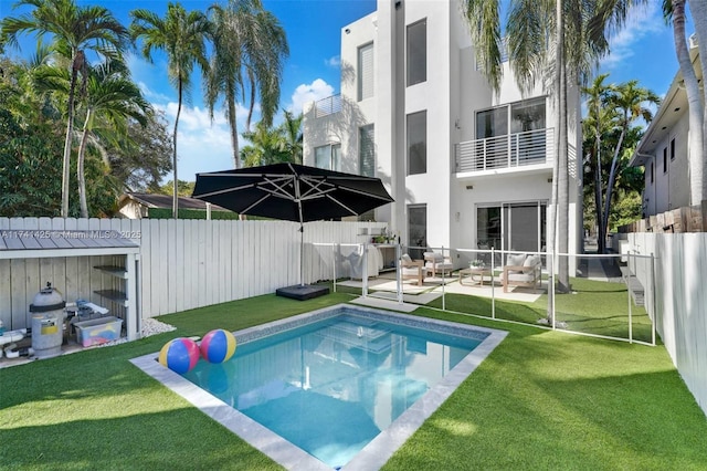 view of swimming pool featuring a fenced backyard, a patio, a fenced in pool, and a yard