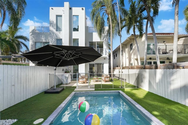 view of swimming pool with a fenced in pool, a fenced backyard, and a yard