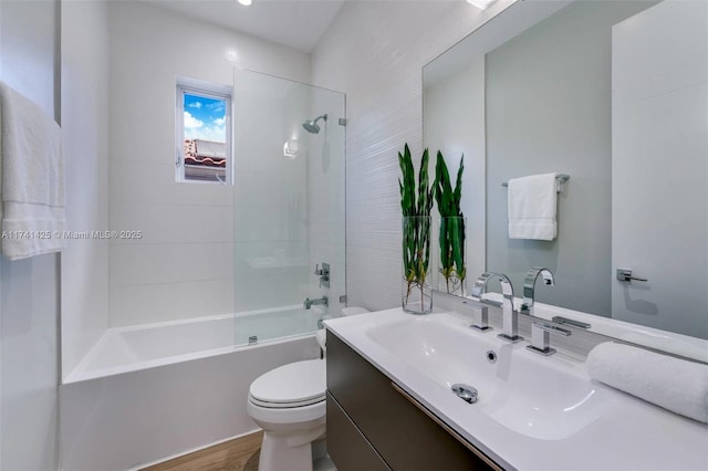 bathroom featuring tub / shower combination, vanity, toilet, and wood finished floors