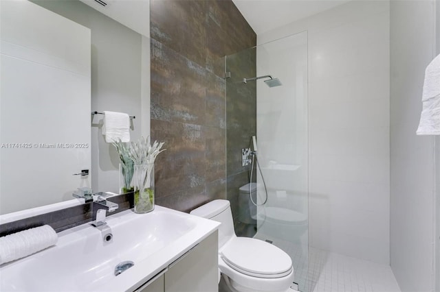 full bathroom with toilet, a walk in shower, vanity, and tile walls