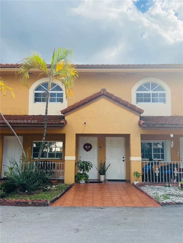 view of property featuring a porch and stucco siding